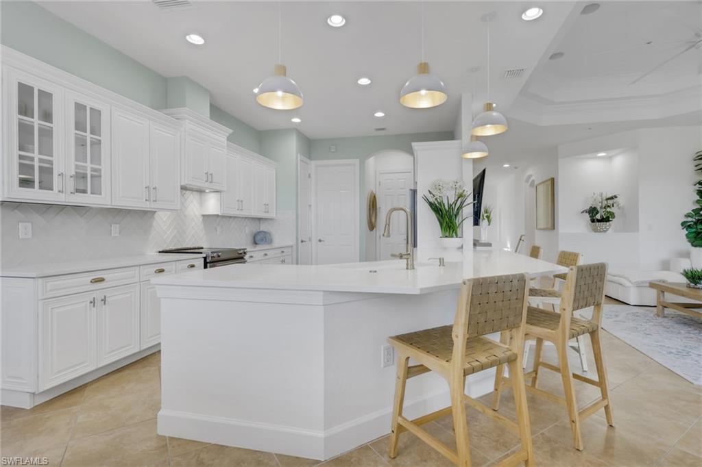 7877 Clemson Street, Unit 202 Naples, FL 34104 - Photo 7 of 36 a kitchen with stainless steel appliances kitchen island granite countertop a sink and cabinets