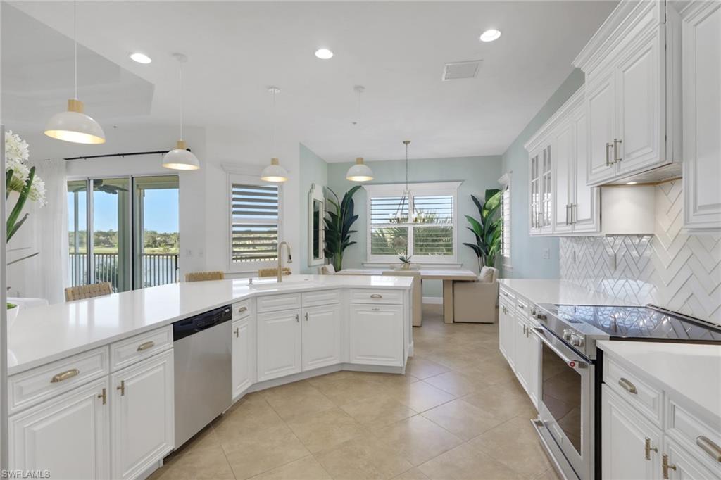 7877 Clemson Street, Unit 202 Naples, FL 34104 - Photo 10 of 36 a large white kitchen with a large window