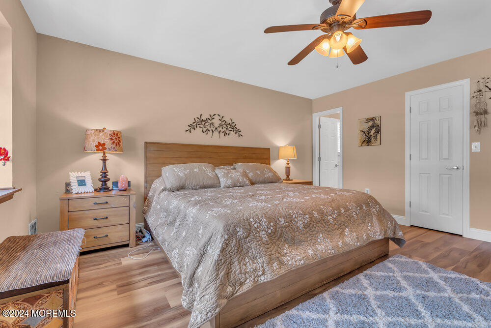 2 Bramble Lane Matawan, NJ 07747 - Photo 18 of 28 a bedroom with a bed and a chandelier