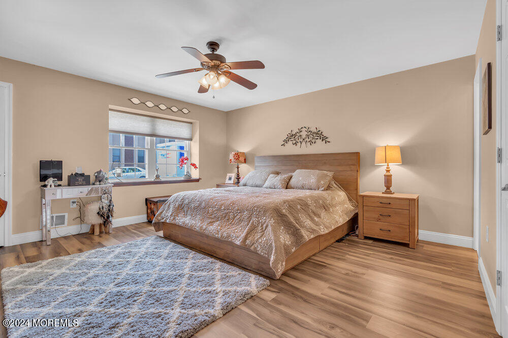 2 Bramble Lane Matawan, NJ 07747 - Photo 19 of 28 a bedroom with a large bed and wooden floor