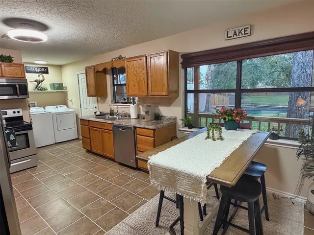 a kitchen with a stove a table and chairs in it