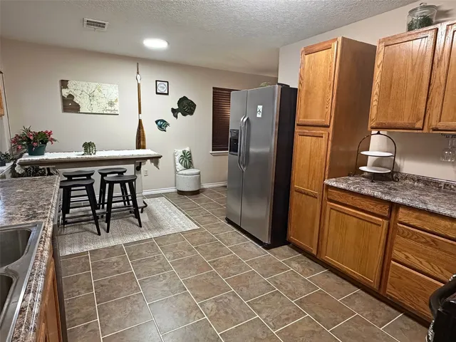 a kitchen with stainless steel appliances a refrigerator and a counter space