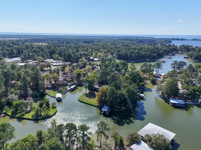 an aerial view of a houses with a lake view