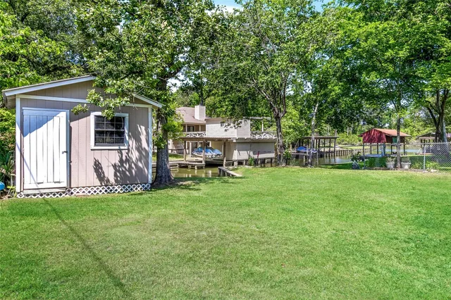 a view of a house with backyard and sitting area