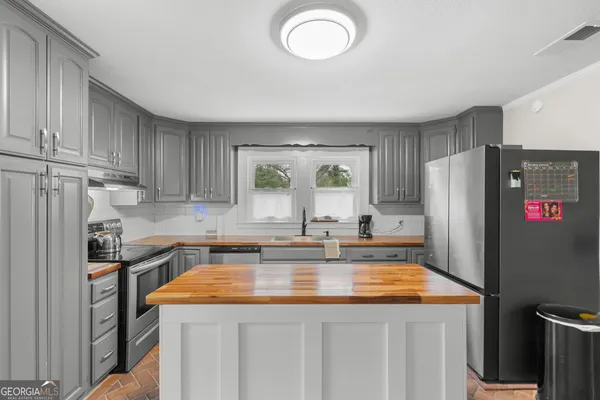 a kitchen with a stove and a sink