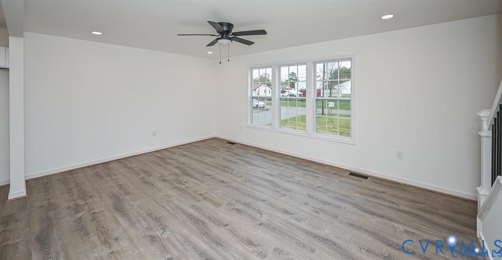 815 Kirby Street West Point, VA 23181 - Photo 4 of 29 a view of an empty room with a window and wooden floor