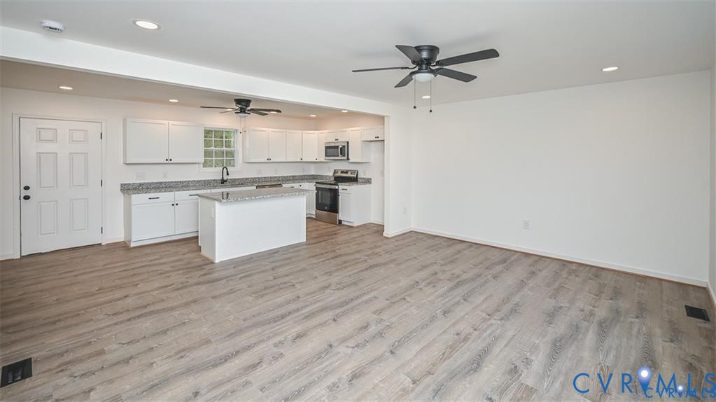 815 Kirby Street West Point, VA 23181 - Photo 5 of 29 a kitchen with a sink cabinets and wooden floor