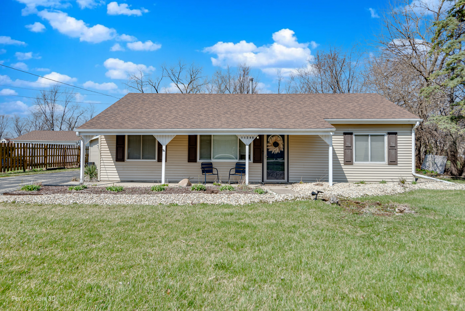 a front view of a house with a garden