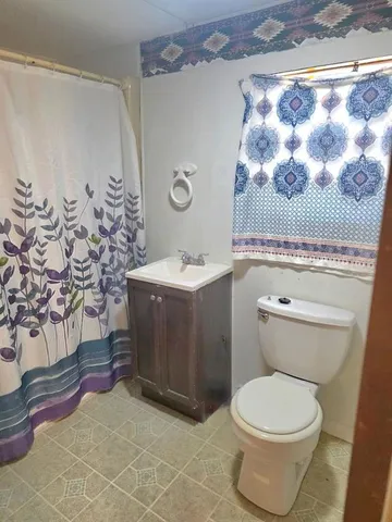 a bathroom with a toilet and a sink