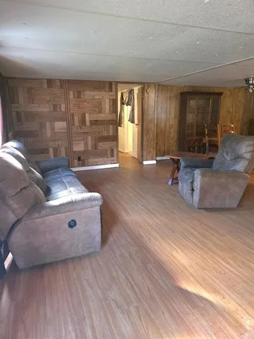 a living room with furniture and large window