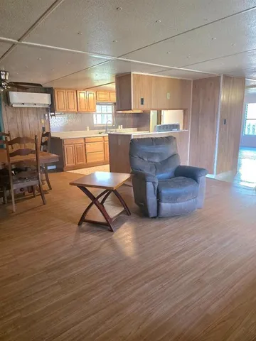 a room with lots of wooden furniture and windows