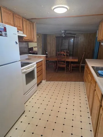 a kitchen with a cabinets and white appliances