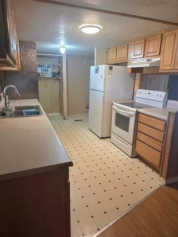 a kitchen with refrigerator and stove