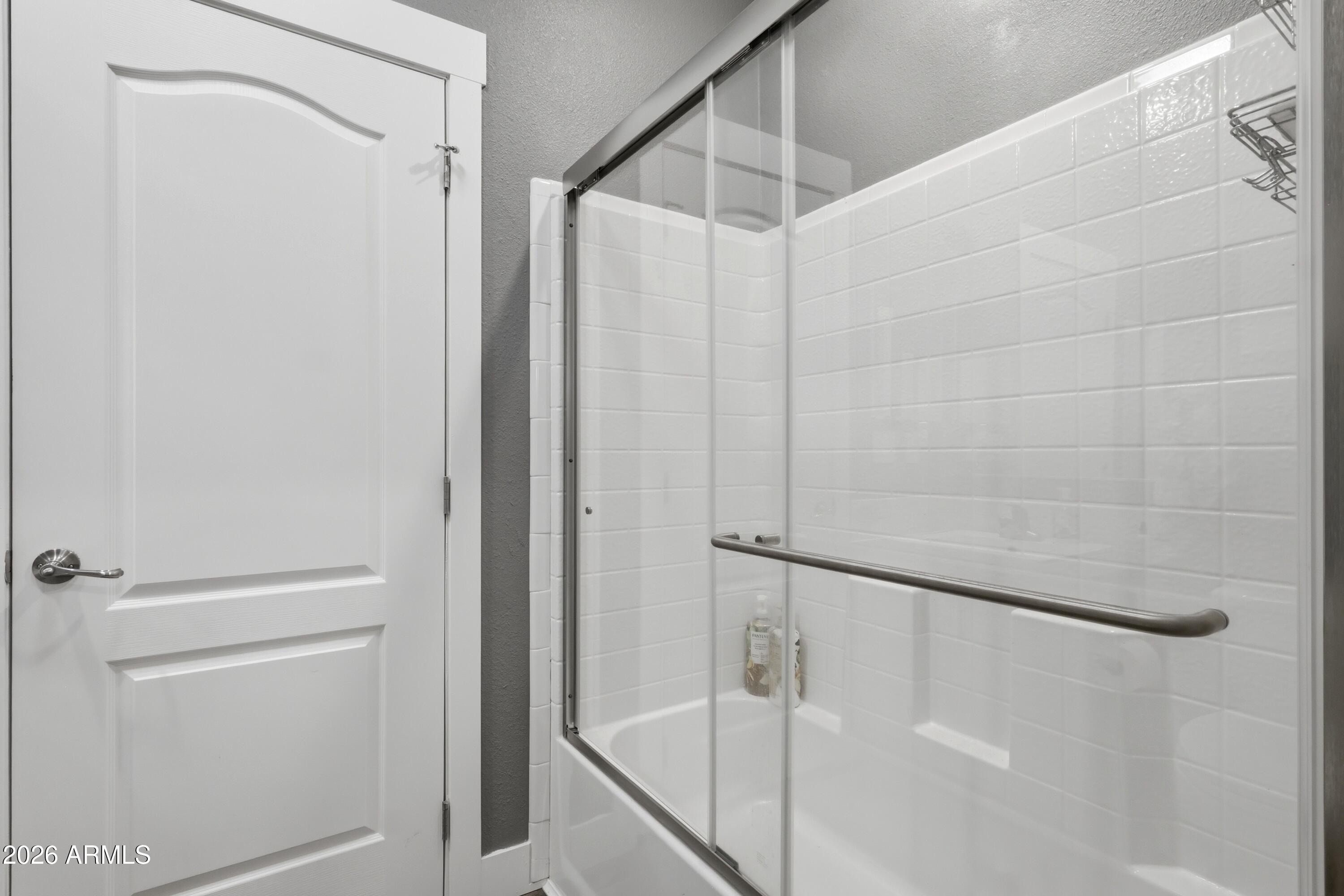 22454 West Steel Horse Road Congress, AZ 85332 - Photo 26 of 44 a bathroom with a shower and a glass door