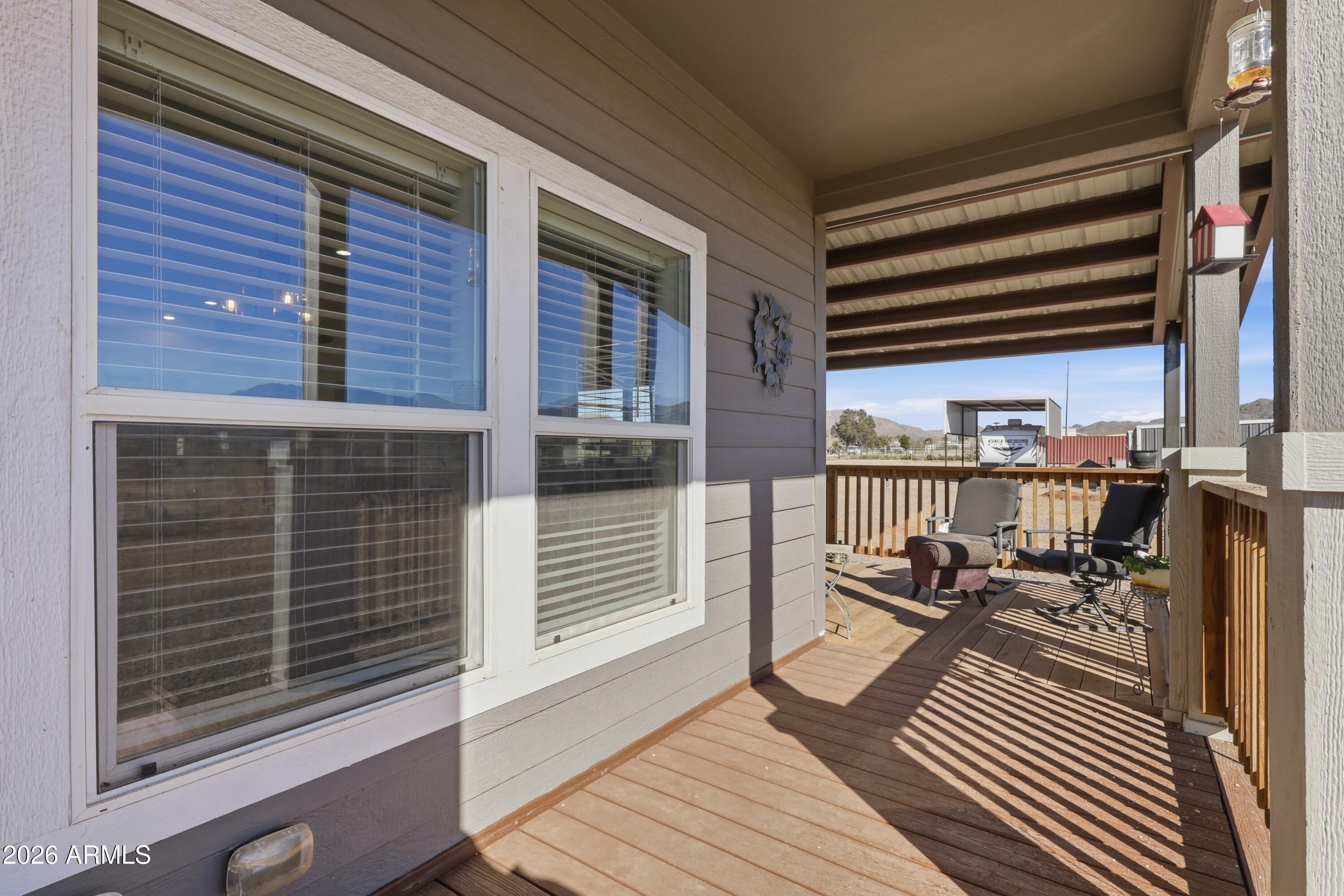 22454 West Steel Horse Road Congress, AZ 85332 - Photo 30 of 44 a balcony with two chairs and a table