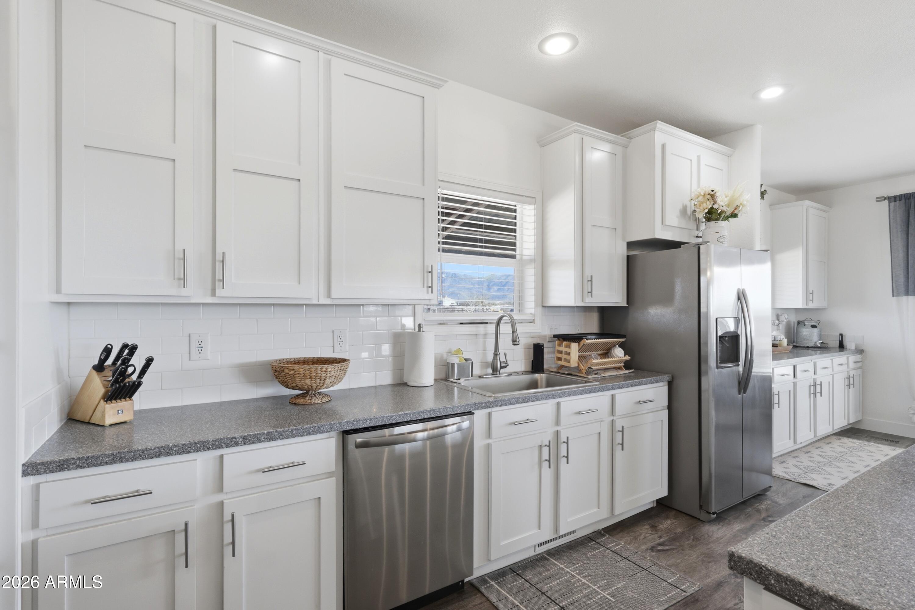 22454 West Steel Horse Road Congress, AZ 85332 - Photo 3 of 44 a kitchen with stainless steel appliances granite countertop a sink a refrigerator a center island and cabinets
