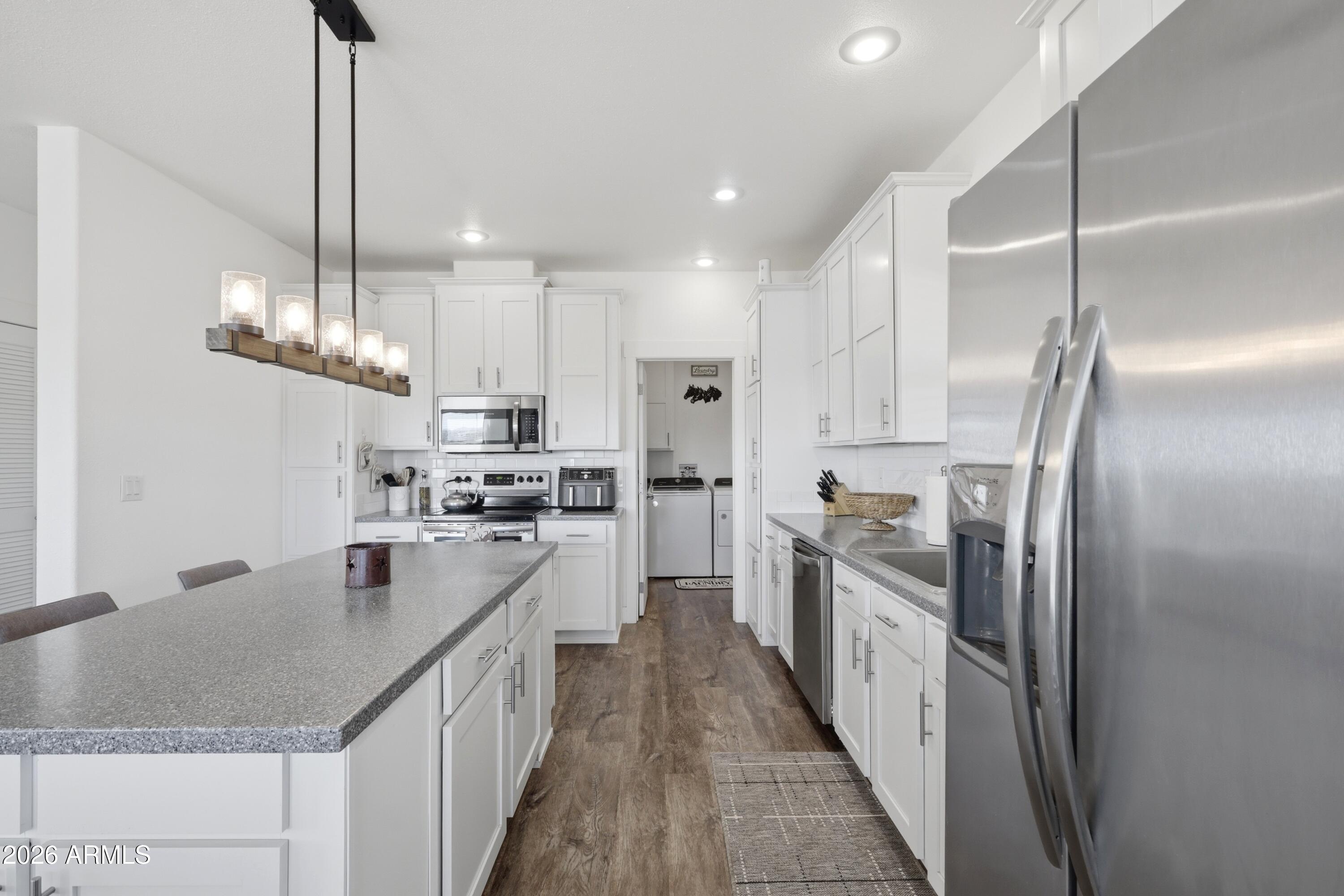 22454 West Steel Horse Road Congress, AZ 85332 - Photo 5 of 44 a kitchen with stainless steel appliances granite countertop a sink a stove and refrigerator