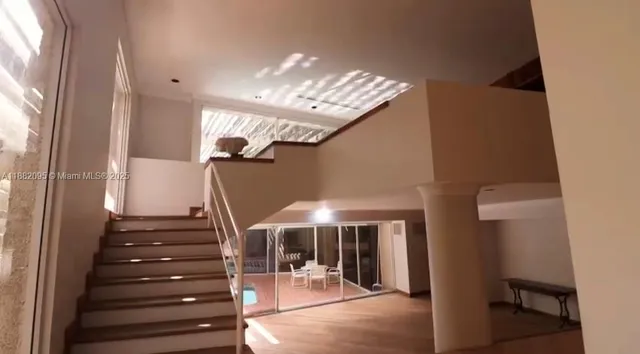 a view of a hallway with an empty room and a window