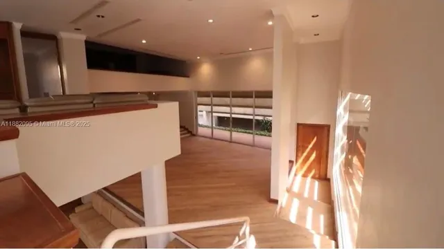 an empty room with closet and windows