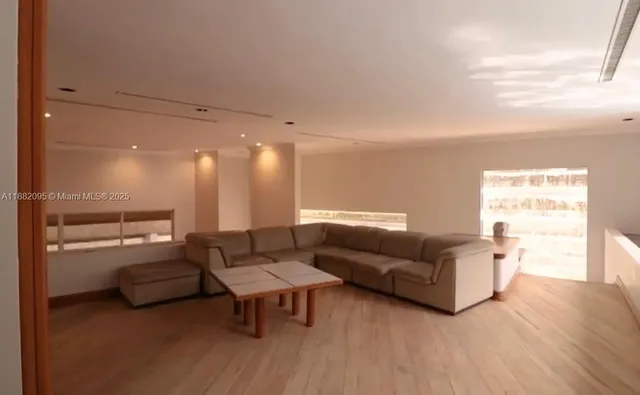 a living room with a bed furniture and a window