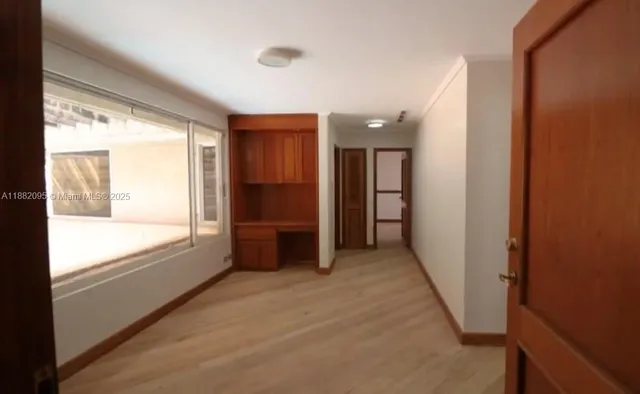 a view of a closet area with wooden floor