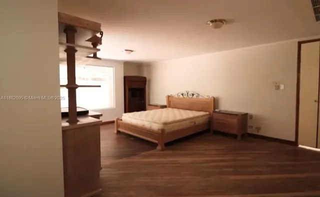 a view of a room with wooden floor and windows