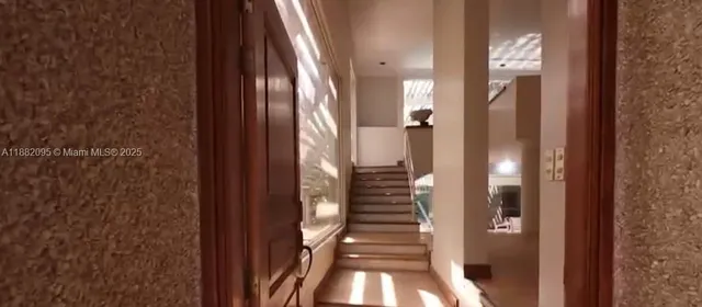 a view of an entryway with wooden floor