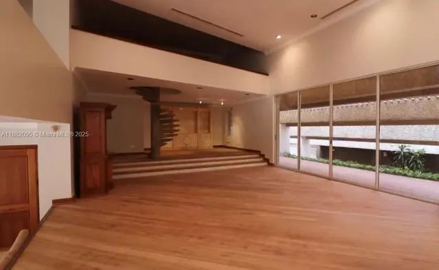 a view of an empty room and wooden floor