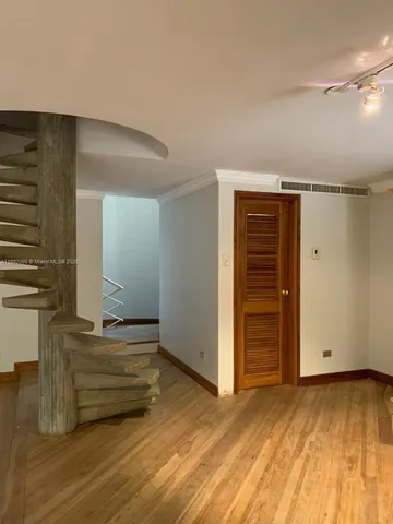 a view of a living room with furniture and floor to ceiling window