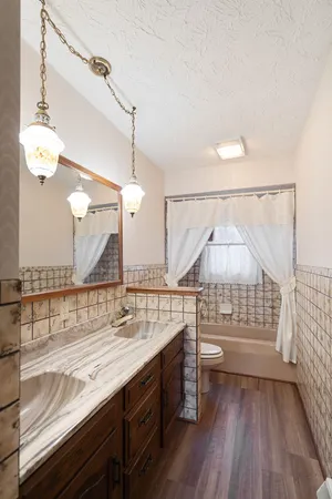 a bathroom with a double vanity sink and a mirror