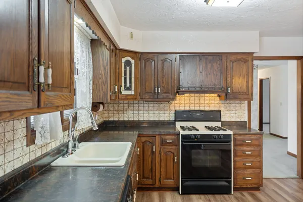 a kitchen with stainless steel appliances a stove a sink and a refrigerator