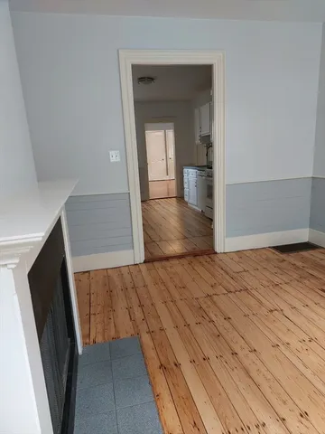 a view of a hallway view with wooden floor and staircase