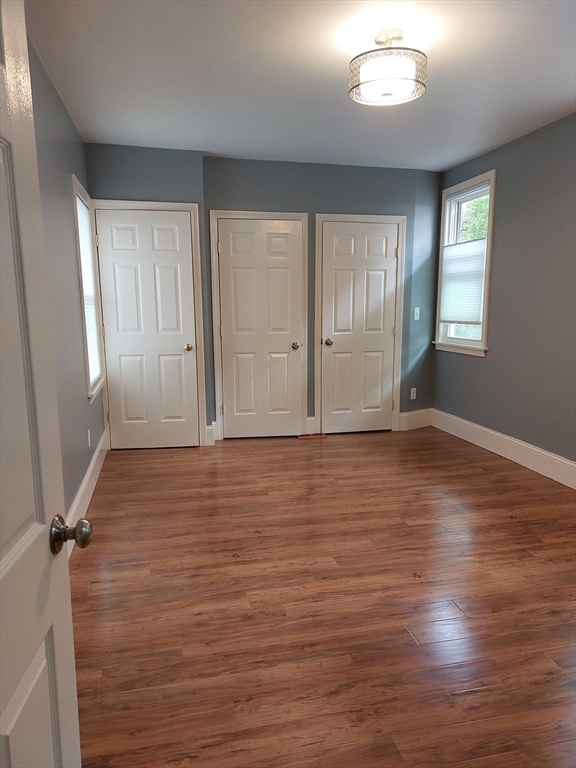26 Eden Street, Unit 1 Boston, MA 02129 - Photo 14 of 23 an empty room with wooden floor and windows