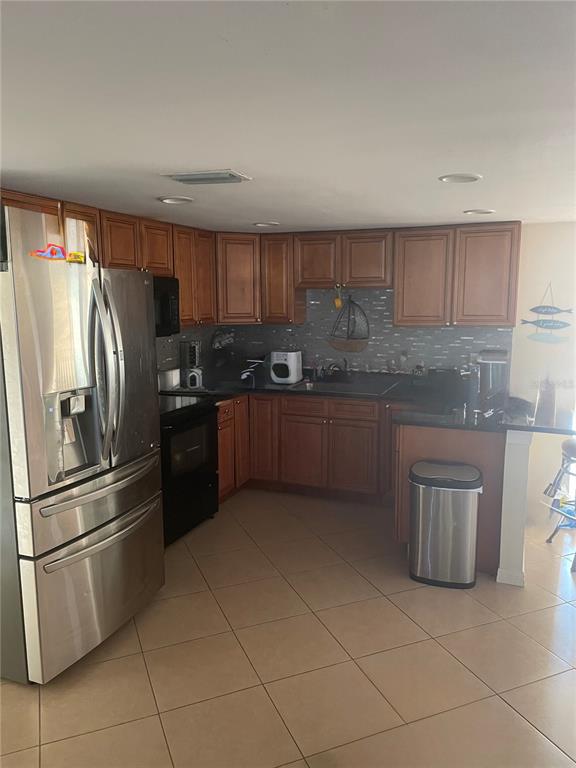 744 Gran Kaymen Way Apollo Beach, FL 33572 - Photo 12 of 12 a kitchen with stainless steel appliances granite countertop a refrigerator sink and stove