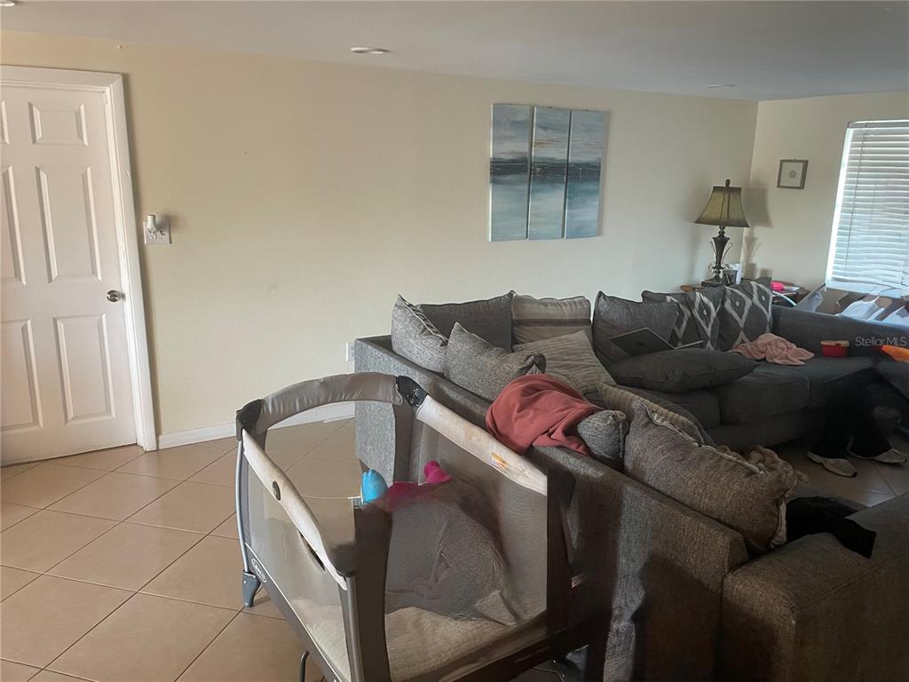 744 Gran Kaymen Way Apollo Beach, FL 33572 - Photo 4 of 12 a living room with furniture and a couch