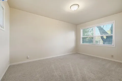 a view of a house with a yard table and chairs under an umbrella