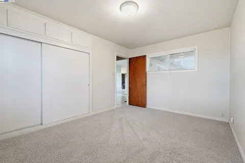 a front view of a house with a garden and patio