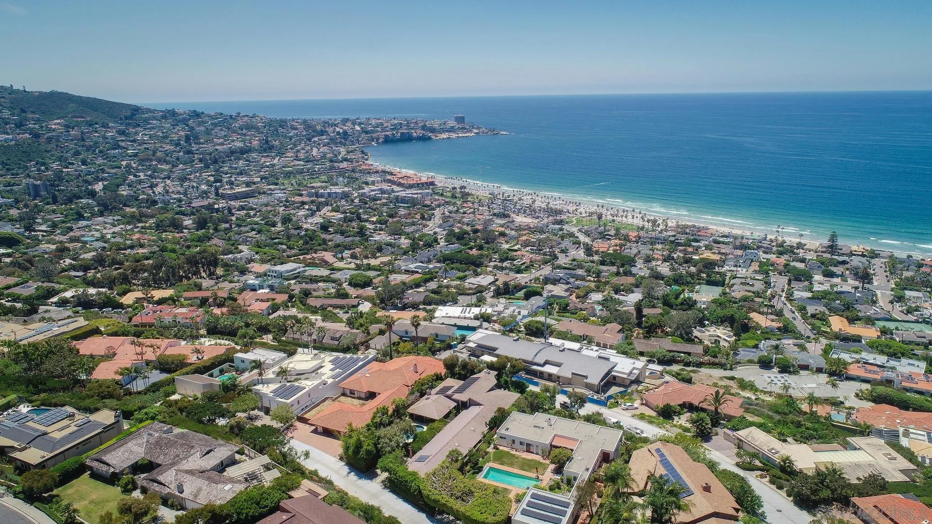 an aerial view of a city with ocean view