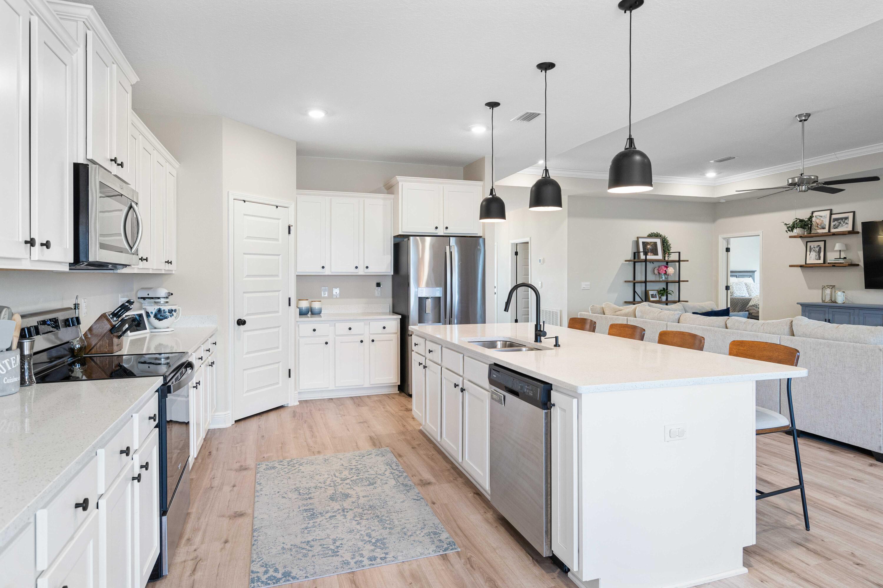 58 Siesta Circle Freeport, FL 32439 - Photo 14 of 40 a kitchen with stainless steel appliances kitchen island granite countertop a sink and white cabinets