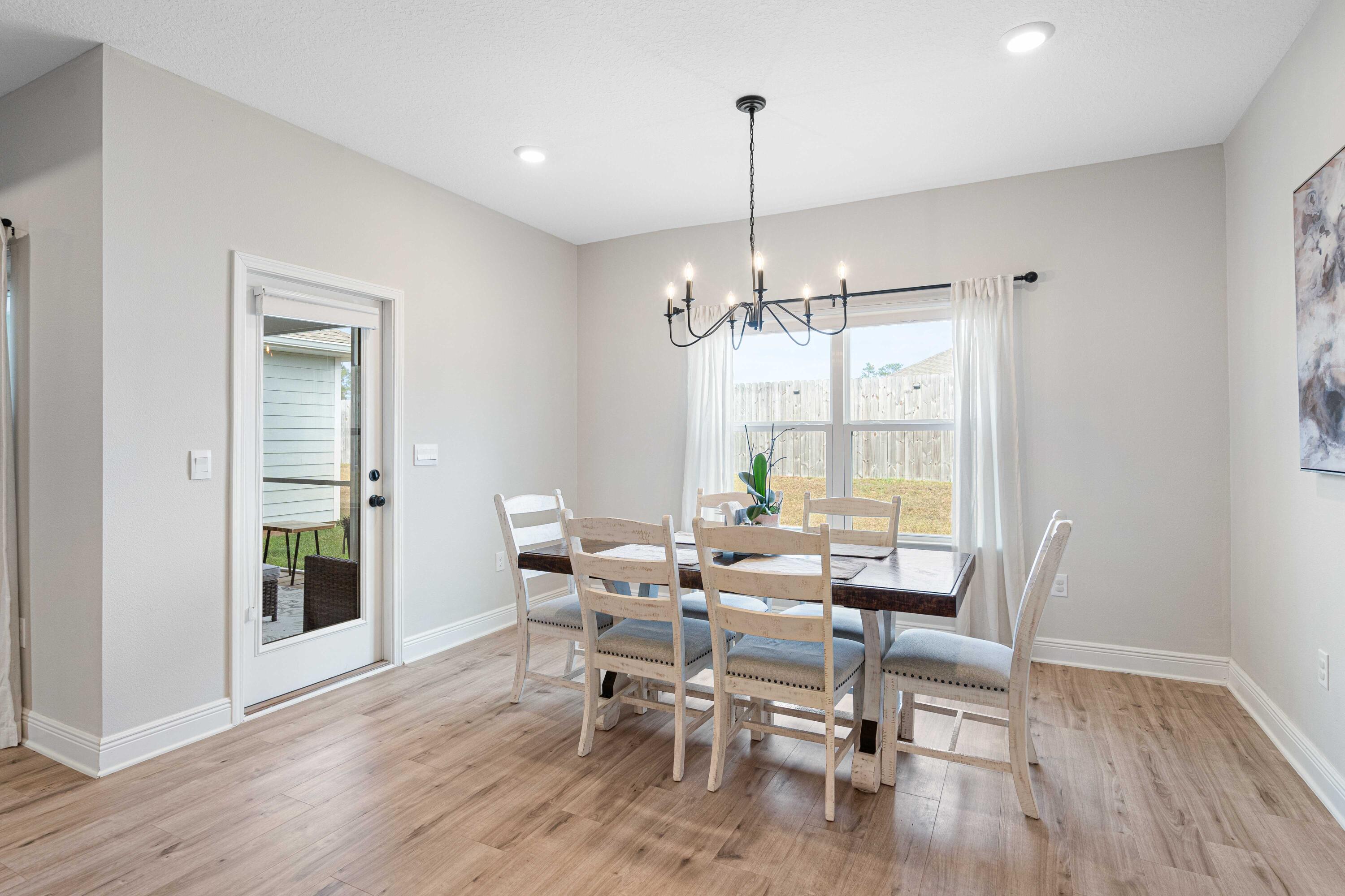 58 Siesta Circle Freeport, FL 32439 - Photo 15 of 40 a view of a dining room with furniture window and wooden floor