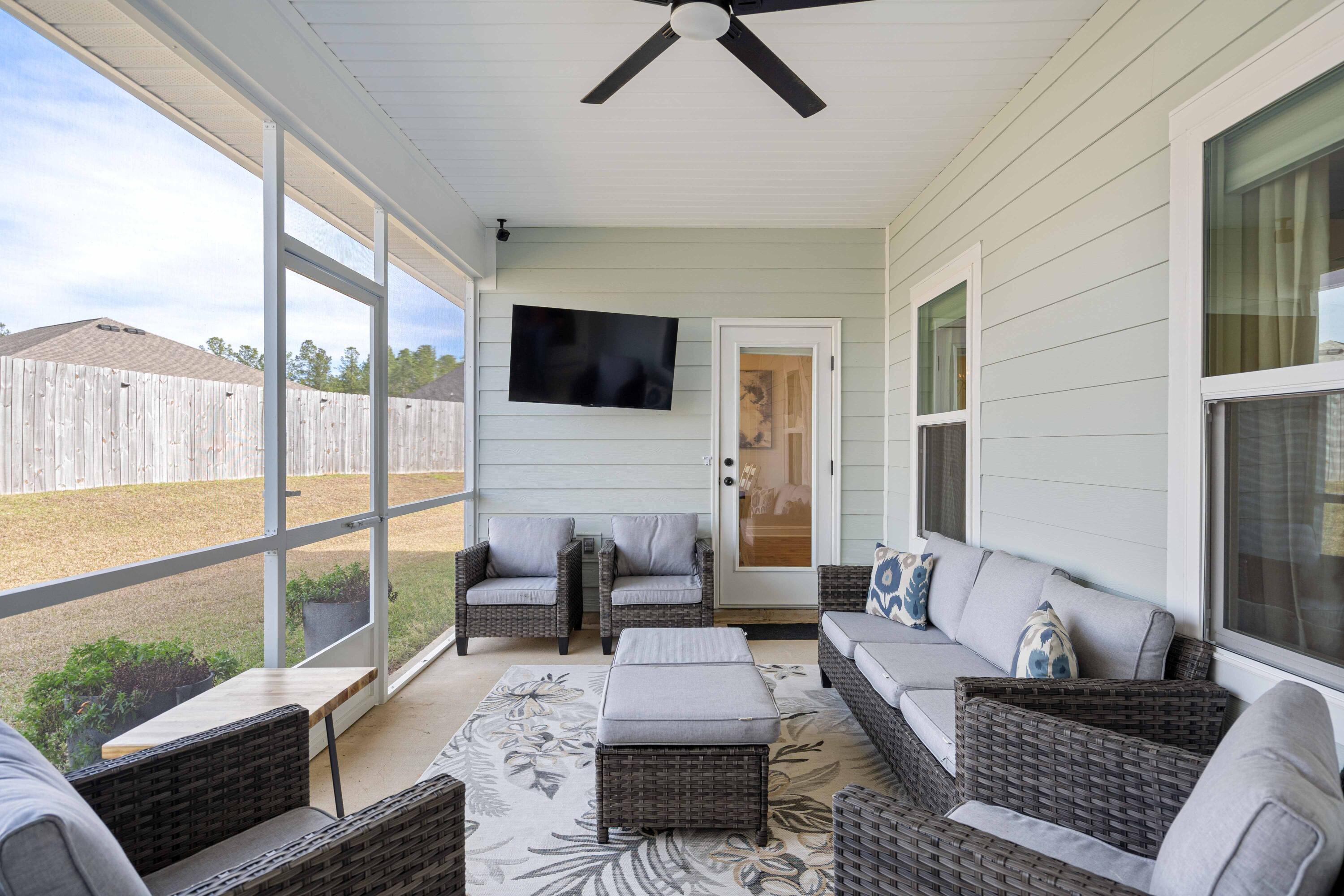 58 Siesta Circle Freeport, FL 32439 - Photo 23 of 45 a living room with furniture floor to ceiling window and a flat screen tv