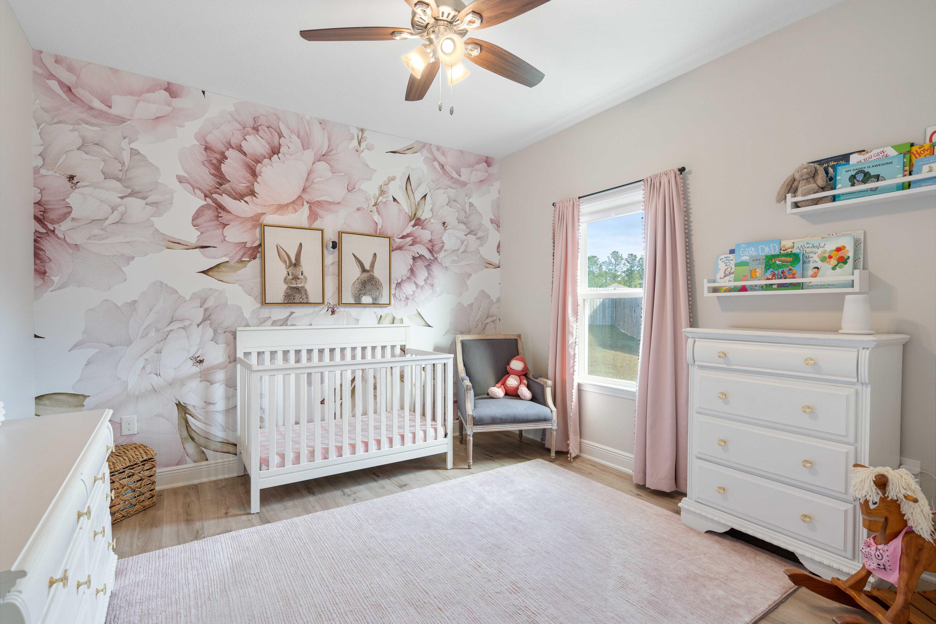 58 Siesta Circle Freeport, FL 32439 - Photo 31 of 45 a bedroom with a baby bed a couch and a window