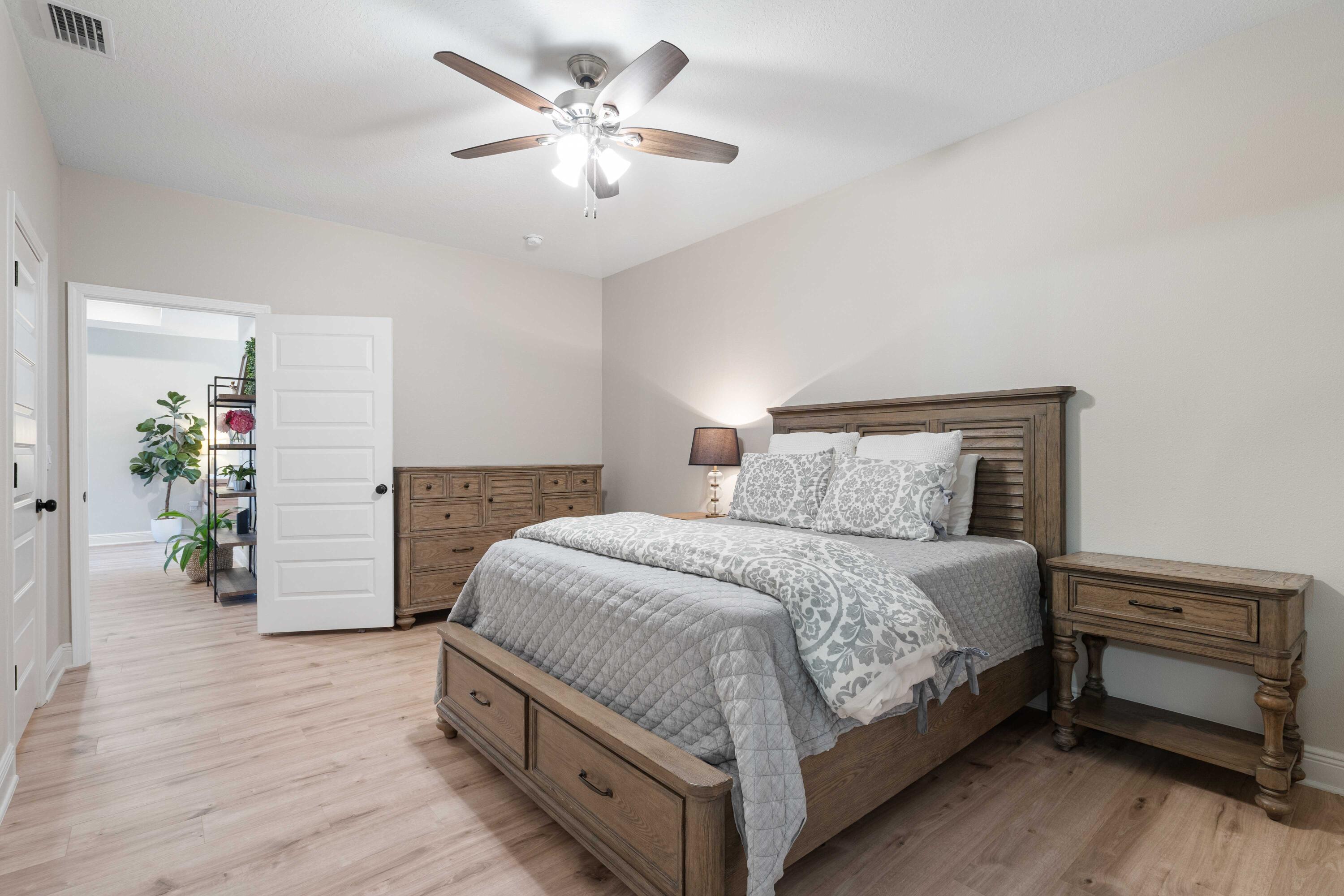 58 Siesta Circle Freeport, FL 32439 - Photo 36 of 45 a bedroom with a bed and a chandelier