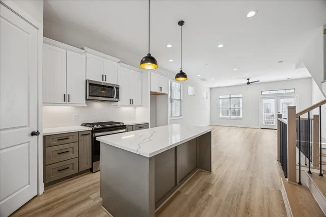 a view of a room with wooden floor and white walls