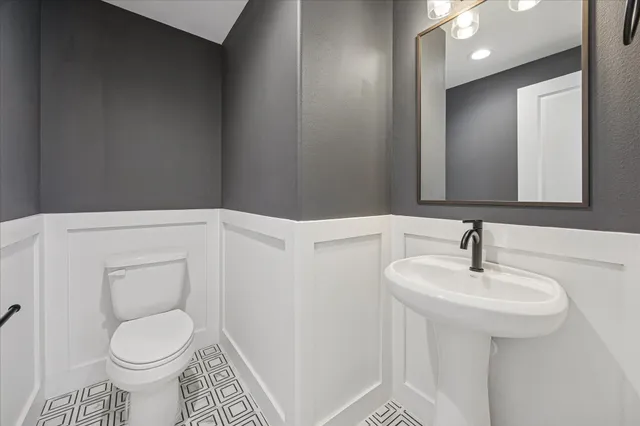 a view of a house with a small yard and wooden floor and fence