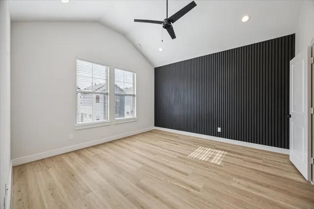 a view of a house with a yard and a large tree