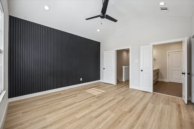 a view of a brick house with a small yard and plants