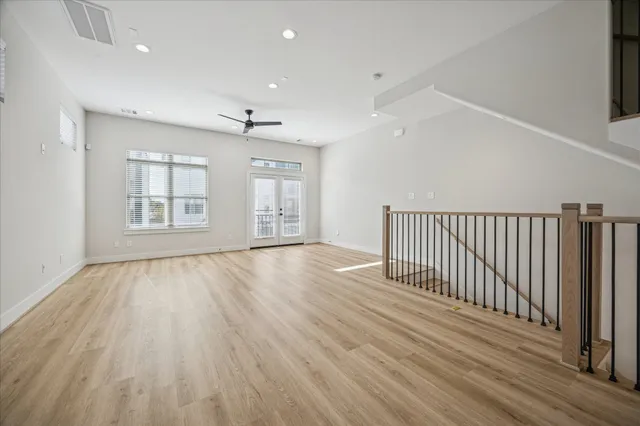 a view of an empty room with wooden floor