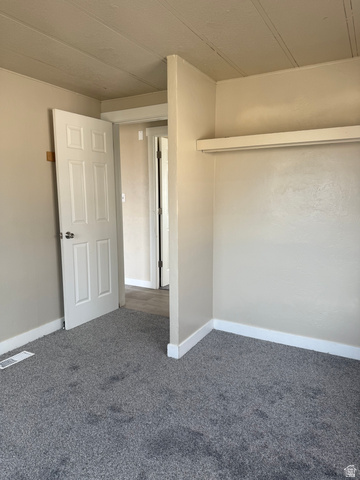 446 Riverside Drive, Unit 24 Wellington, UT 84542 - Photo 11 of 14 Unfurnished bedroom featuring carpet floors and baseboards