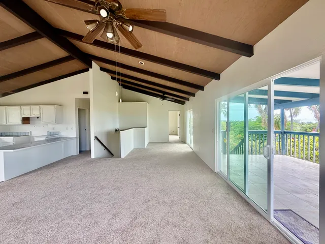 a view of a kitchen with microwave and windows